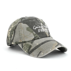 Detailed view of white letter embroidery on a camouflage cotton twill baseball cap