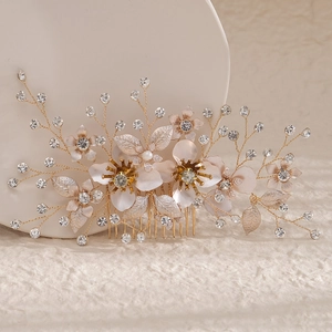 Golden bridal hair comb with elegant white flowers, leaves, pearls, and rhinestones