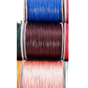 Multiple colors of durable waxed polyester cord on reels for DIY jewelry making and crafts