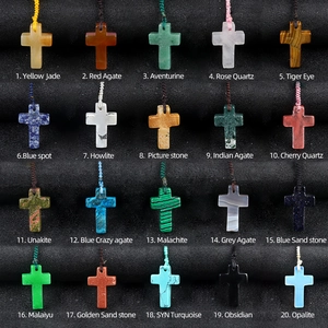 Variety of 20 natural crystal agate cross pendants displayed in a professional black box