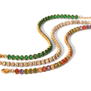 Gold tennis bracelets with emerald, white, and rainbow cubic zirconia in a curved layout