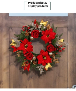 Detail of Christmas wreath with red roses and pine cones on a dark wooden door