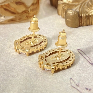 Detailed back view of golden oval earrings with secure stud back and beaded edge finish