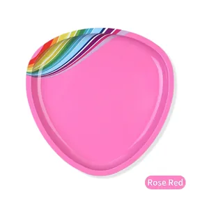 Macro shot of rose red triangular stainless steel storage tray with rainbow stripe accent
