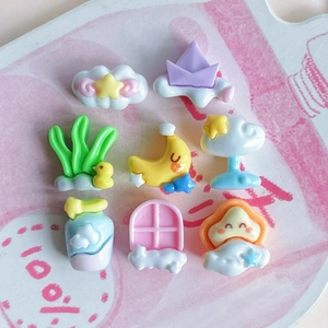 Flat lay of colorful mini resin charms featuring stars, moon, and cute duck shapes