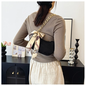 Elegant black underarm bag with gold chain strap and vintage ribbon bow detail