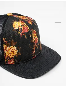 Detail of floral straw crown with breathable mesh and crocodile pattern faux leather brim