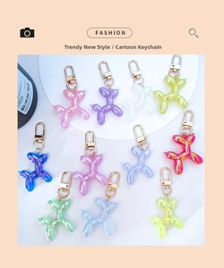 Detailed flat lay of ten colorful gradient resin balloon dog keychains with gold hooks