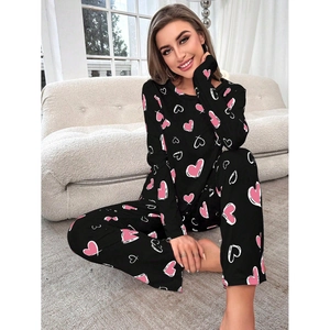 Cozy women's black pajamas set with pink heart print on soft knit long sleeve and pants