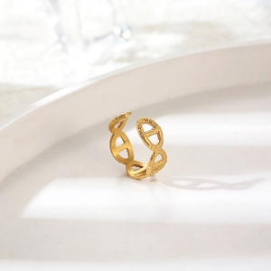 Detailed close-up of 18K gold H-link ring with unique hammered texture on white ceramic
