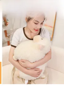 Macro detail of plush lamb toy being held to show soft texture and plump shape