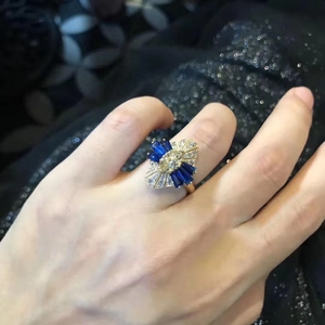 Close-up of 18K gold plated ring featuring yellow oval zircon and blue baguette sapphire