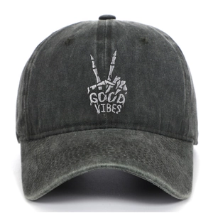 Close-up of skeleton hand embroidery and Good Vibes text on washed cotton baseball cap