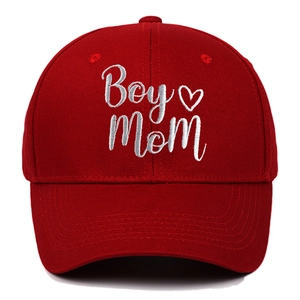 Close-up of white Boy Mom embroidery and heart detail on red cotton baseball cap