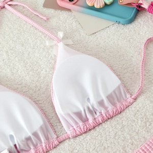 Detail of pink gingham bikini top featuring inner mesh lining and cute white bow ornament
