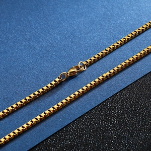 Detail of golden stainless steel box chain necklace with a classic lobster clasp closure