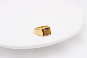 Detailed view of a gold-plated stainless steel ring with a square tiger eye gemstone