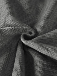 Macro shot of dark grey soft fleece fabric with luxury spiral texture and ribbed detail