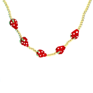 Gold beaded necklace with five red strawberry resin charms on a clean white background