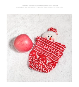 Close-up of a festive red knitted Christmas gift bag with a 3D snowman and snowflake motifs