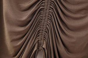 Macro detail of brown ruched fabric with drawstring texture for women's hooded tops