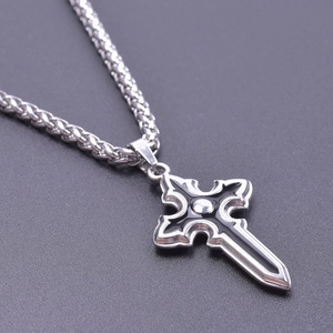 Detailed macro view of silver and black stainless steel cross sword pendant on wheat chain
