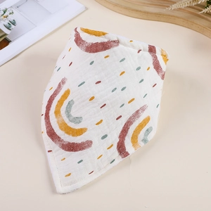 Double-layered muslin baby bib with rainbow print on a minimalist cream background