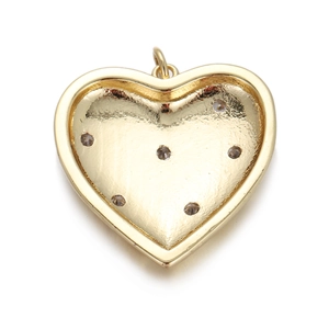Detailed close-up of a gold heart pendant with textured grooves and polished finish
