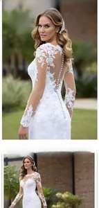 Detail of white lace wedding dress featuring elegant pearl buttons and sheer mesh back