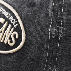 Macro detail of vintage washed cotton baseball cap with GOODTIMESROLL embroidery