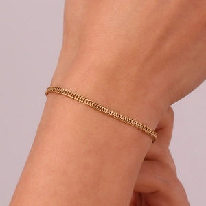 Close-up of elegant 18K gold plated foxtail chain bracelet worn on a woman's wrist