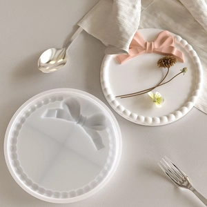 Round silicone mold for DIY resin tray featuring bead edge and bow decoration