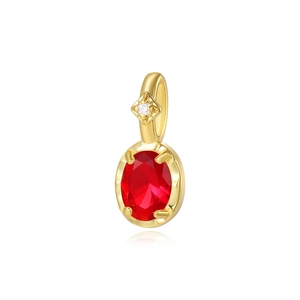 Close-up of golden turtle pendant with oval red gemstone and clear crystal accent