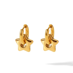 Macro detail of gold stainless steel hoop earrings featuring polished star-shaped pendants
