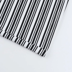 Close-up of black and white striped knit fabric showing high-quality stitching detail