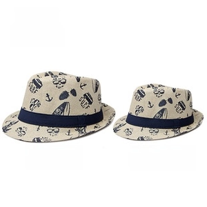 Detail of adult and child straw fedora hats with blue nautical summer print patterns