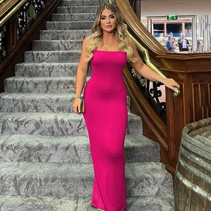 Elegant backless rose red maxi dress worn by a model standing on a grand staircase