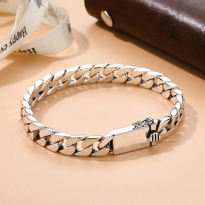 Classic silver metal Miami Cuban link bracelet for men with box clasp on elegant background