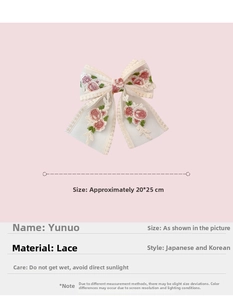 Detail of white lace bow hair clip with pink rose embroidery on a soft pink background