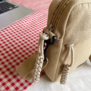 Mini khaki canvas crossbody phone bag for women with woven zipper puller detail