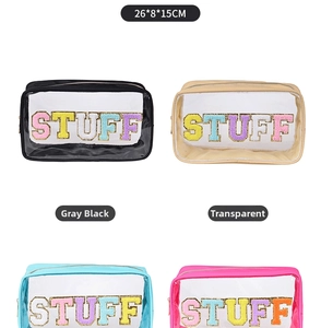 Detail view of four colorful transparent PVC toiletry bags with STUFF towel embroidery