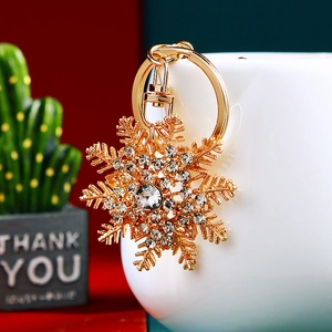 Macro shot of gold snowflake keychain with sparkling crystals and metal finish