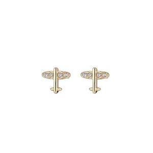 Macro detail of gold airplane stud earrings featuring sparkling inset crystals