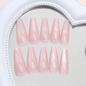 Glossy cat eye press-on nails in dusty rose pink displayed on a heart mirror