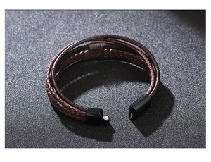 Macro shot of multi-layer braided leather bracelet with black magnetic clasp detail