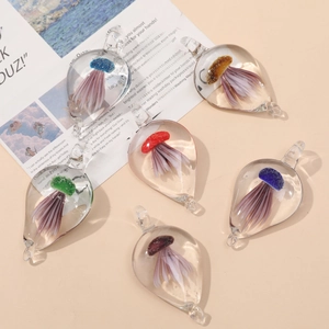 Water-drop shaped glass pendants featuring realistic jellyfish inside in multiple colors
