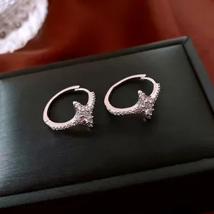 Silver star-shaped hoop earrings with micro-pave cubic zirconia in minimalist style