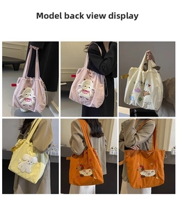 Detail showing various colors of drawstring canvas tote bags worn by a model