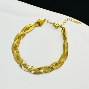 Detailed view of triple-braided gold snake chain bracelet with lobster clasp and extender