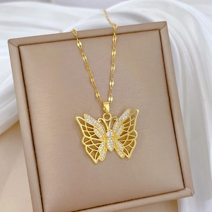 Detailed view of a gold-plated titanium steel hollow butterfly pendant with zircon crystals